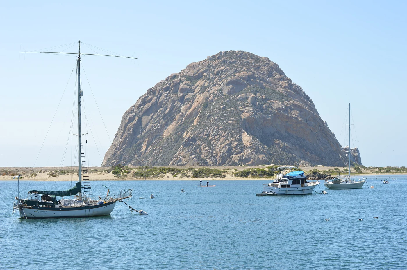 Sailboats in Morro Bay harbor beneath Morro Rock